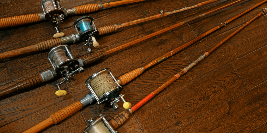 Vintage fishing rods on wooden floor