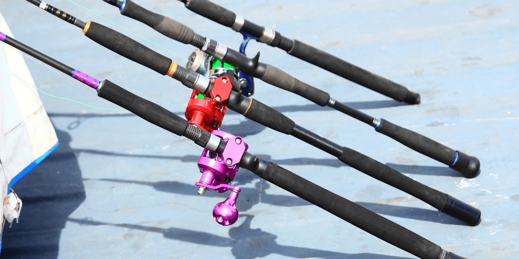 Colorful fishing rods on a blue surface.
