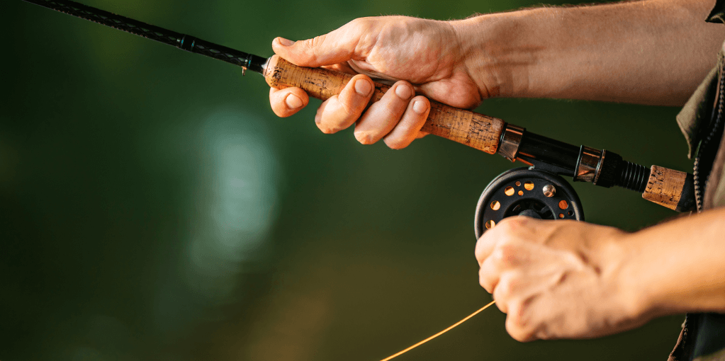 Hands holding a fishing rod